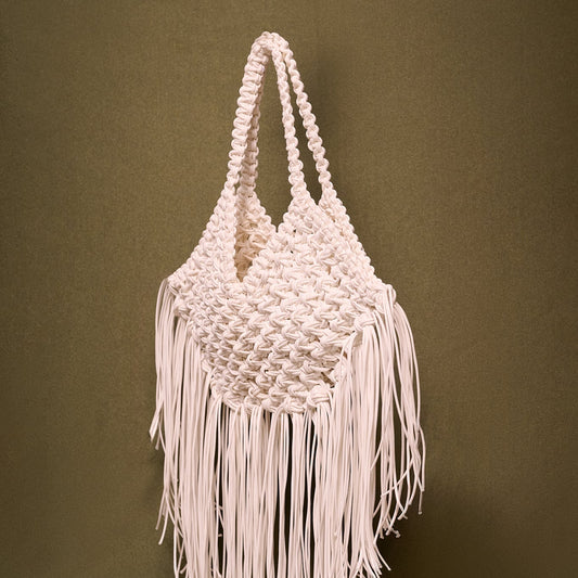 Macrame bag with fringes on a olive background