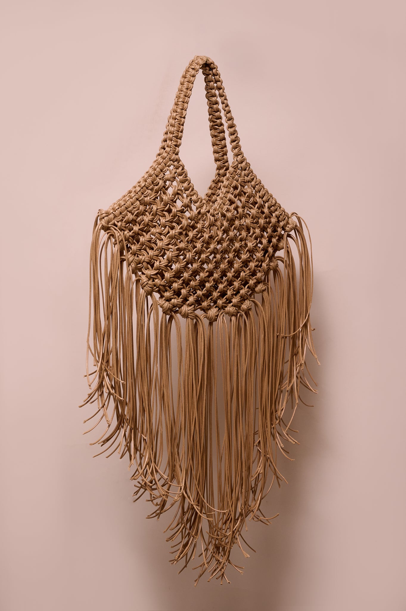 Brige macrame handbag with fringes on a white background